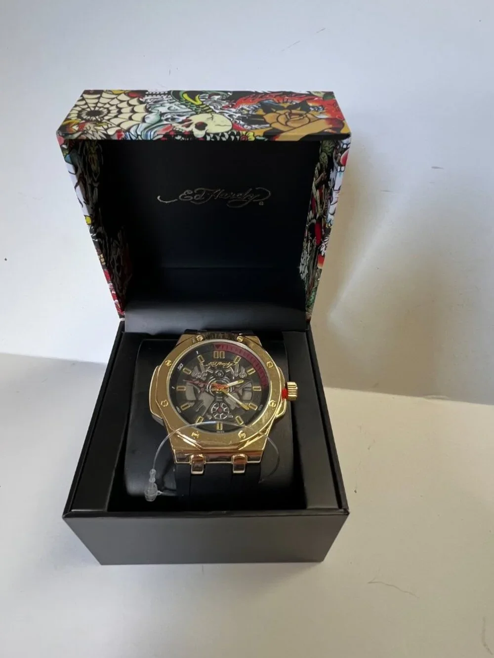 Ed Hardy men's sport wristwatch. Black rubber band. Gold case. Analog. Skeleton…